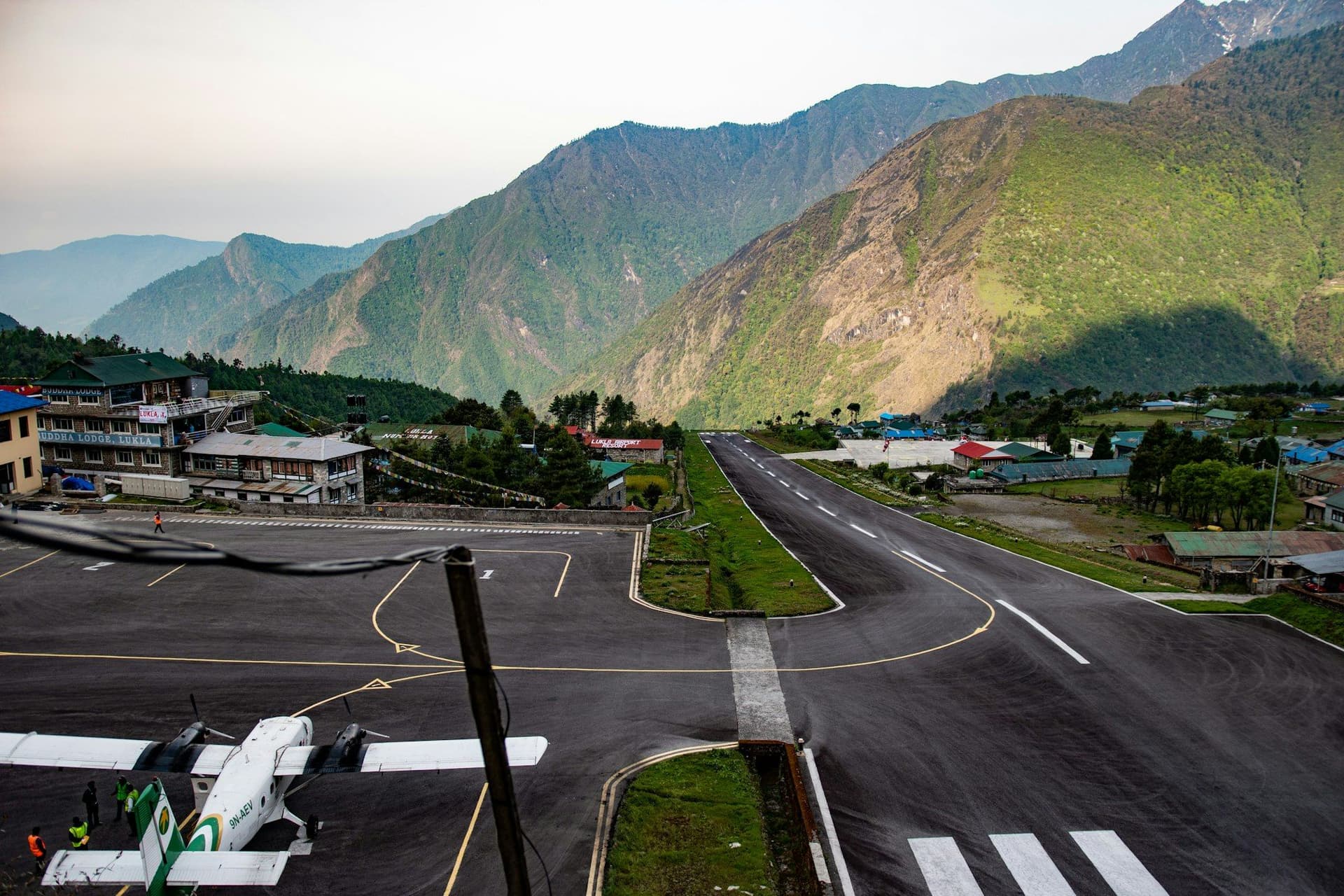 A short mountain runway with ridges rising behind it