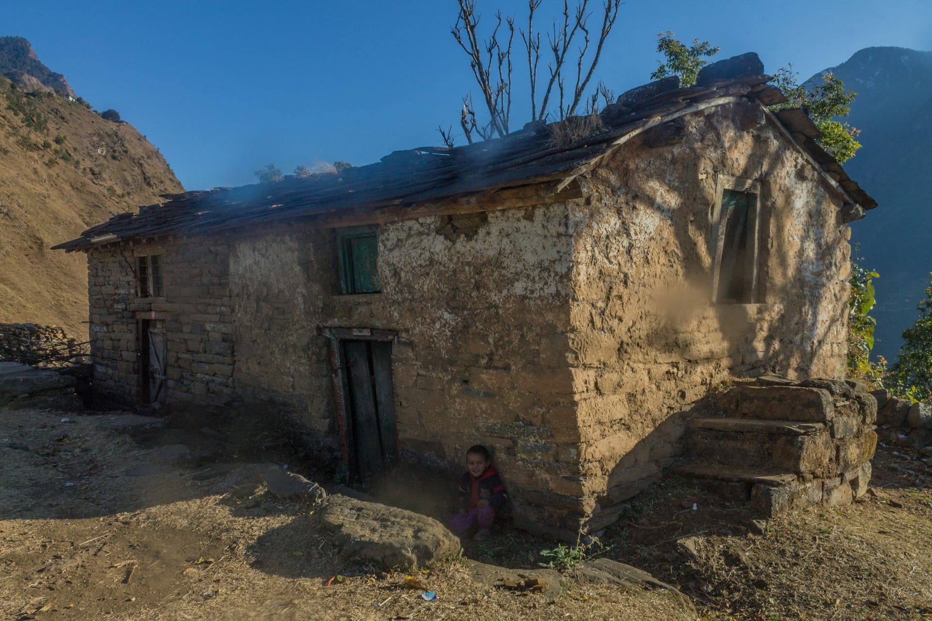 An old stone house with worn steps in a hill village