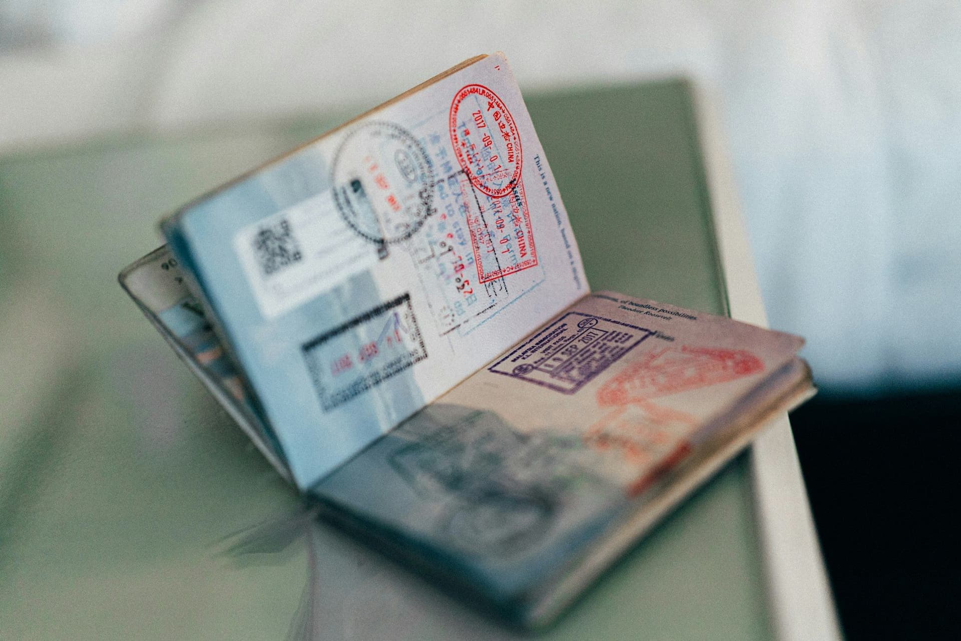 An open passport covered in entry and exit stamps